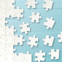 white puzzle pieces on blue background Weißes Puzzle hinter einem blauen Hintergrund