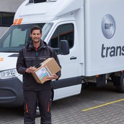 trans-o-flex Fahrer lächelnd bei Auslieferung